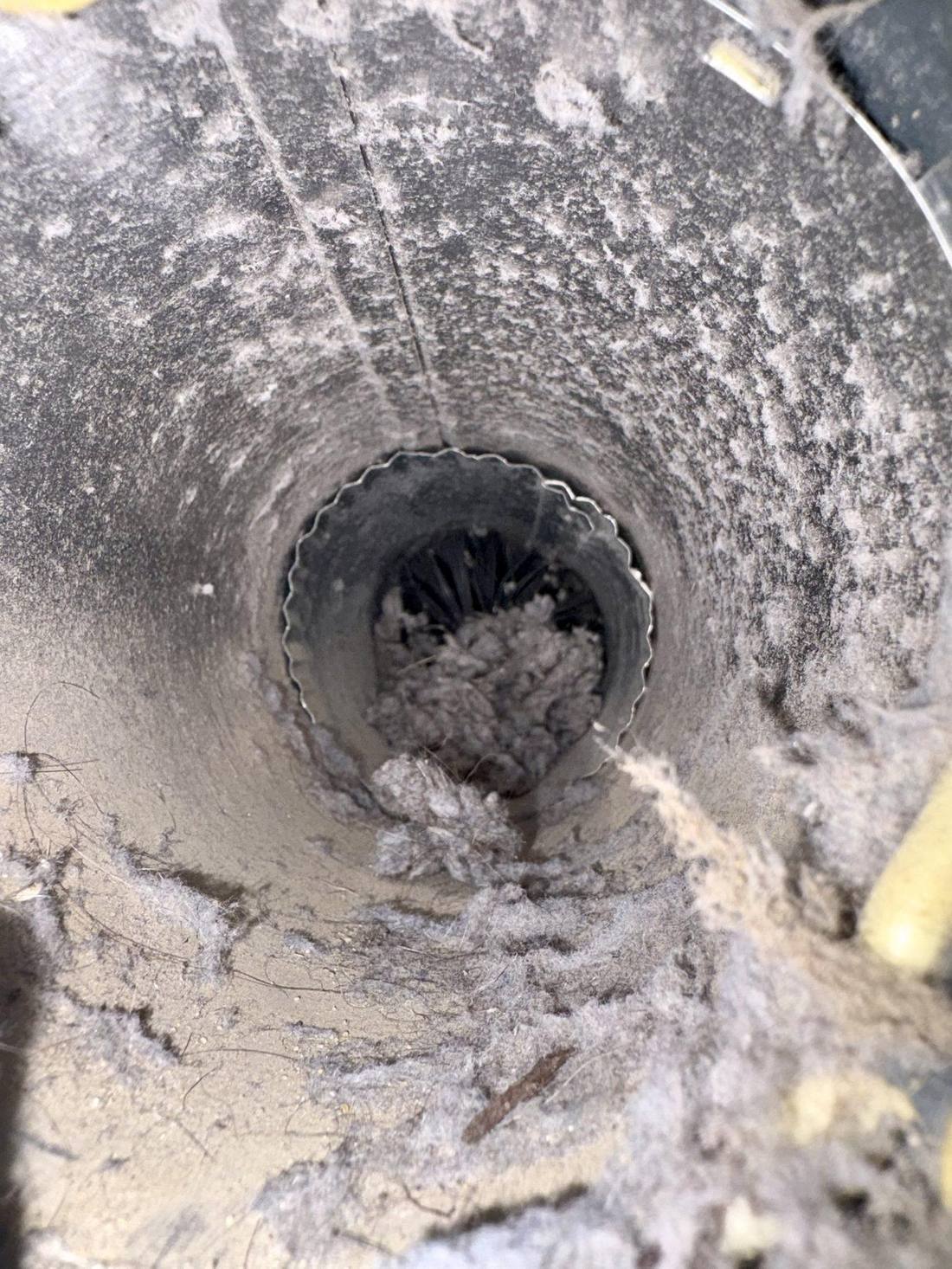 Dryer vent duct heavily clogged with lint before cleaning